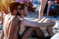Two friends relax together on Fire Island Pines Beach, sharing a quiet moment during a summer afternoon, photographed by koitz.