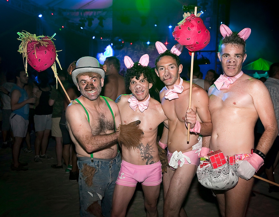 Four partygoers wearing Three Little Pigs-themed costumes pose during the annual Pines Party in Fire Island.
