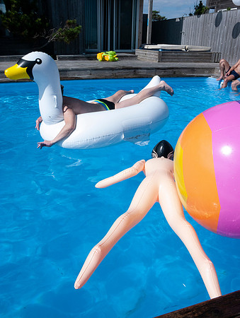 A lively pool party at a private house in Fire Island Pines, capturing summer gatherings, friendship, nightlife, and the vibrant social atmosphere of the Pines.