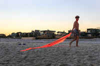 Performer entertaining a crowd on the beach in Fire Island Pines during a summer LGBTQ community event.