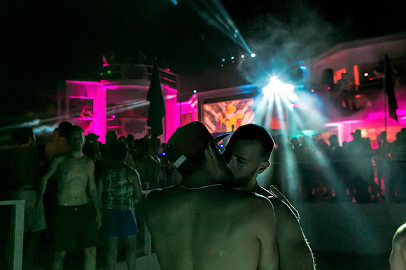 Two men kissing at the BayDance party in Fire Island Pines, photographed by koitz