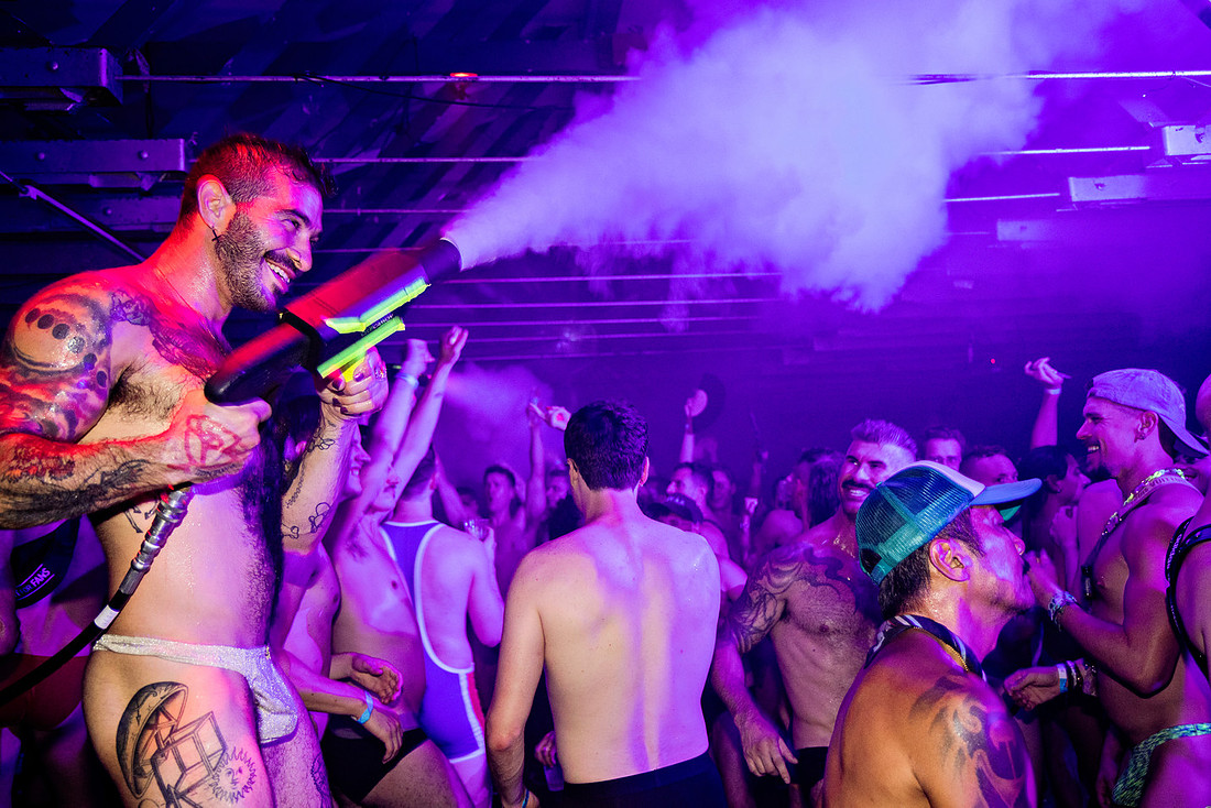 Partygoers gather at the Ice Palace in Cherry Grove during the DWorld Fire Island Underwear Party, dressed in underwear and festive party attire while socializing and celebrating inside the iconic Fir