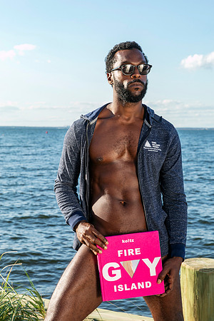 Model holding photo book koitz Gay Fire Island