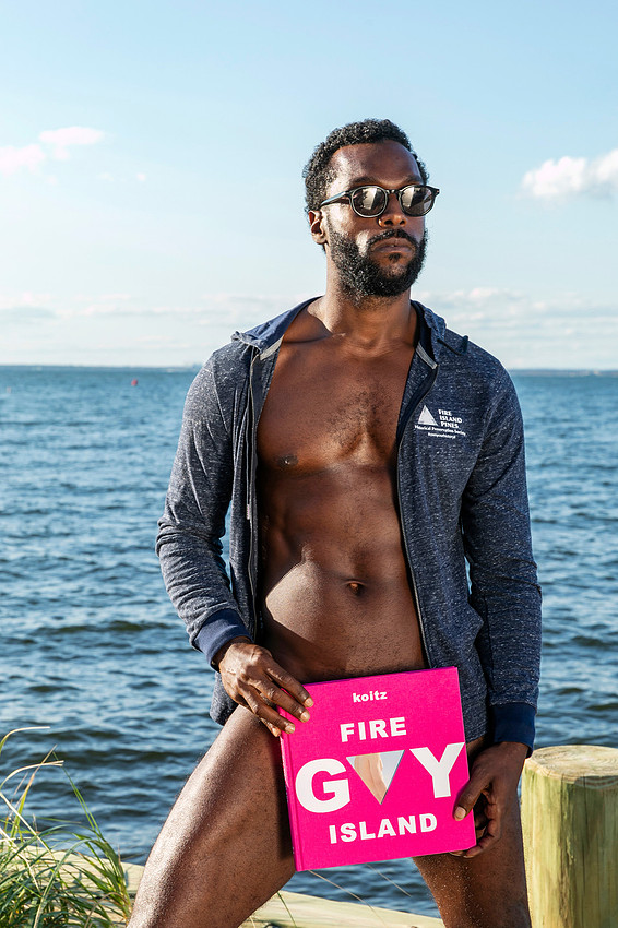 Model holding photo book koitz Gay Fire Island