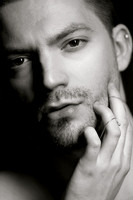 Black and white portrait of a male model wearing a chain, from the queer gay photography series by koitz.