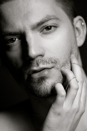 Black and white portrait of a male model wearing a chain, from the queer gay photography series by koitz.