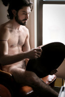 Model posing beside a mirror in a queer fashion portrait by koitz.