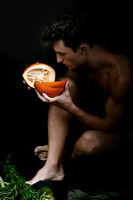Artistic portrait of a model posing with fruit in a creative queer gay photography editorial by koitz.
