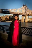 Brock wearing a dress while posing on the 59th Street Bridge in New York City.