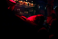 Go-go boy lying on a bar at Bedlam in New York City, photographed by koitz Photography.