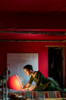 Portrait of Brock wearing a dress while sitting in bed in a contemporary queer photography artwork by koitz.