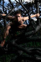 In this intimate photograph from Koitz’s The Meat Rack Series, Brock looks directly into the camera from within the charred landscape of Fire Island. Surrounded by burnt branches and blackened trees l