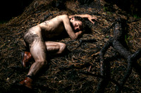 Brock on the ground among the burnt trees in the Meat Rack on Fire Island, photographed by koitz.
